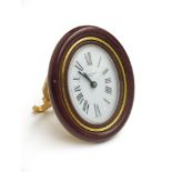 A Cartier alarm clock in mauve enamel and gilt metal strut case, No. 7519 10679.
