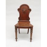 A Victorian mahogany hall chair, the shaped solid back on turned tapering legs, height 89.