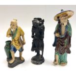 Two Chinese pottery figures and a carved wood figure.