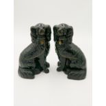 A pair of Victorian black pottery spaniel figures, of Jackfield type, with gilt decoration,