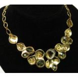 A Monica Vinader silver gilt necklace set with faceted yellow stones and diamonds.