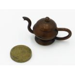 A Russian miniature model of a teapot made from copper kopeck coins,