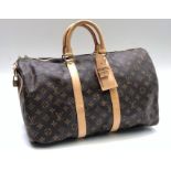 A Louis Vuitton monogram holdall, cow hide leather trim, fabric lined interior,