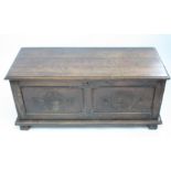 A continental oak coffer, 18th century with carved double panel front and sides on block feet,