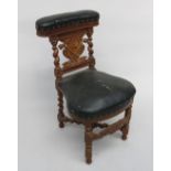 A Victorian oak pipe smokers chair, the top rail with a hinged compartment,