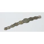 A silver eight coin bracelet 37g.