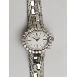 An impressive Le Monde 18ct white gold ladies watch, the oval dial within a 24 diamond bezel,