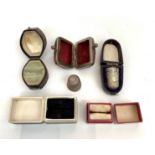 Two silver thimbles and cases together with three ring boxes.