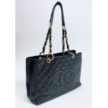 A Chanel black leather quilted bag, with chain and leather straps and interior zipped compartments,