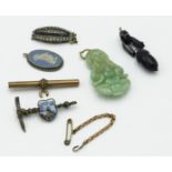 An Art Deco paste set silver necklace clasp, a Chinese jade pendant, etc.