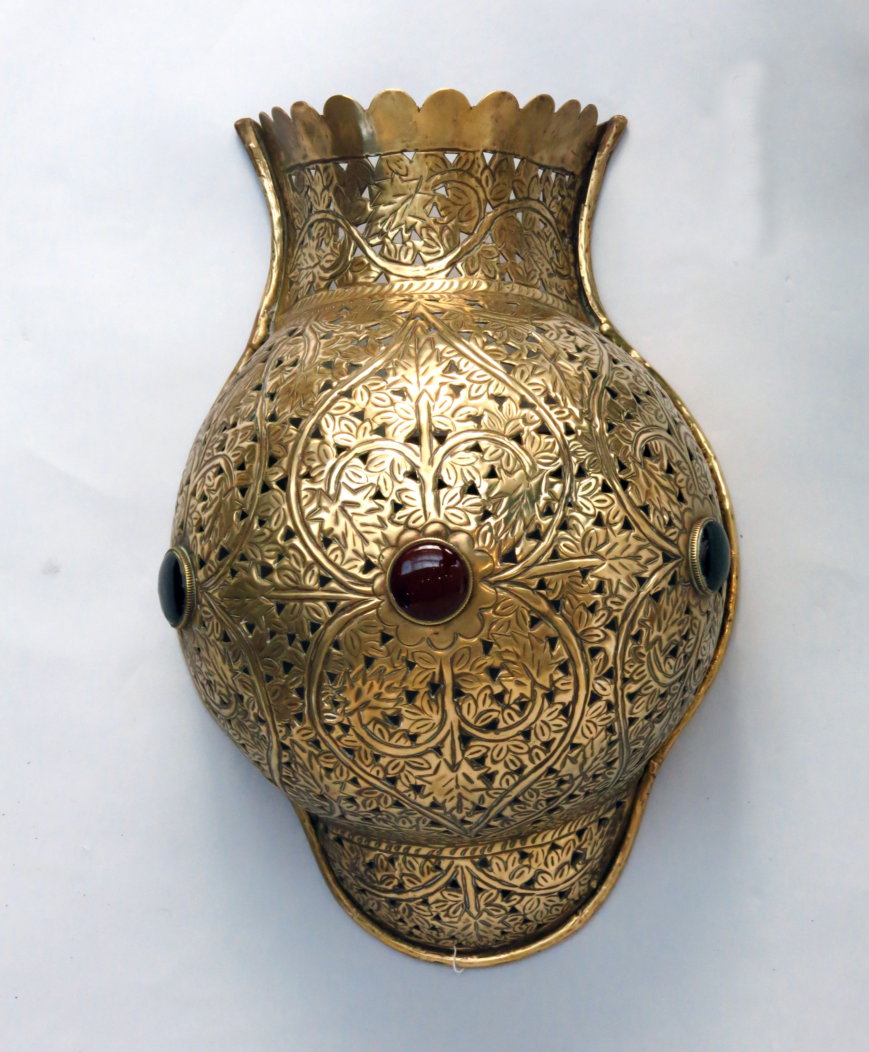 An Islamic pierced brass wall lampshade of urn form,