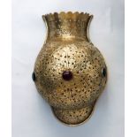 An Islamic pierced brass wall lampshade of urn form,