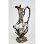 An elegant late 19th century silver mounted glass claret jug decorated with flowers and foliage,