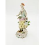 A Derby figure of a shepherdess, 18th century, modelled with a lamb at her feet,