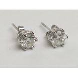 A pair of good diamond earrings each of approximately 1ct spread set in white gold.