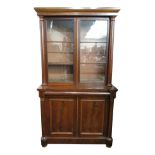 A Victorian mahogany bookcase, with a pair of glazed doors flanked by circular columns,