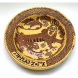 A large slipware charger in the style of Thomas Toft,