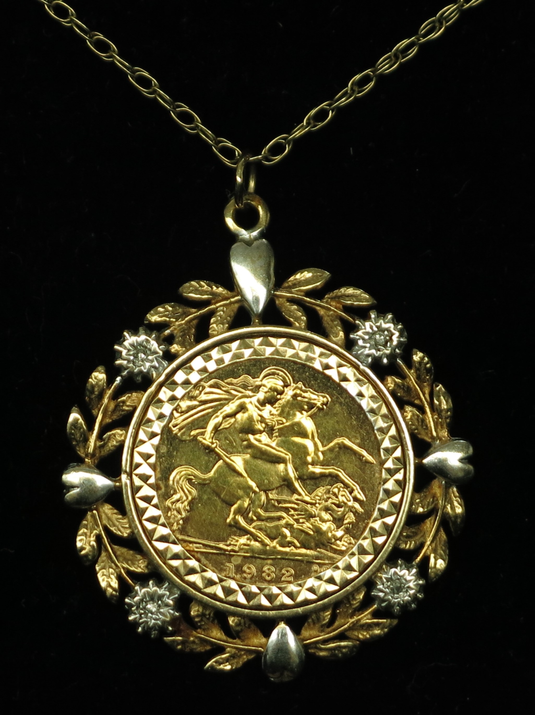 A 1982 half sovereign in 9ct two colour gold diamond set pendant mount on fine gold chain, 9.5g.