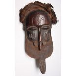 An African wooden Basuku tribal mask, Congo, height 50cm width 24cm.