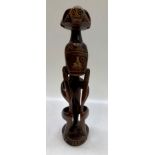 A carved wood figure of a man, possibly Oceanic, height 41cm.