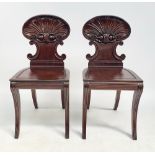 A pair of Regency mahogany hall chairs, in the manner of Gillows,