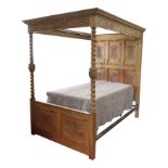 A Jacobean style light oak four poster bed,