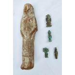 An Egyptian terracotta ushabti figure, length 15.5cm, together with four small amulet pendants.