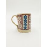 A spongeware pottery mug, 19th century, probably continental, with a simple repeated design,