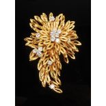 A fine Boucheron high purity gold floral spray brooch set with 14 brilliant cut diamonds,