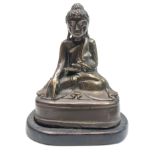 A Chinese bronze buddha on a wooden stand, height of buddha 16.5cm.