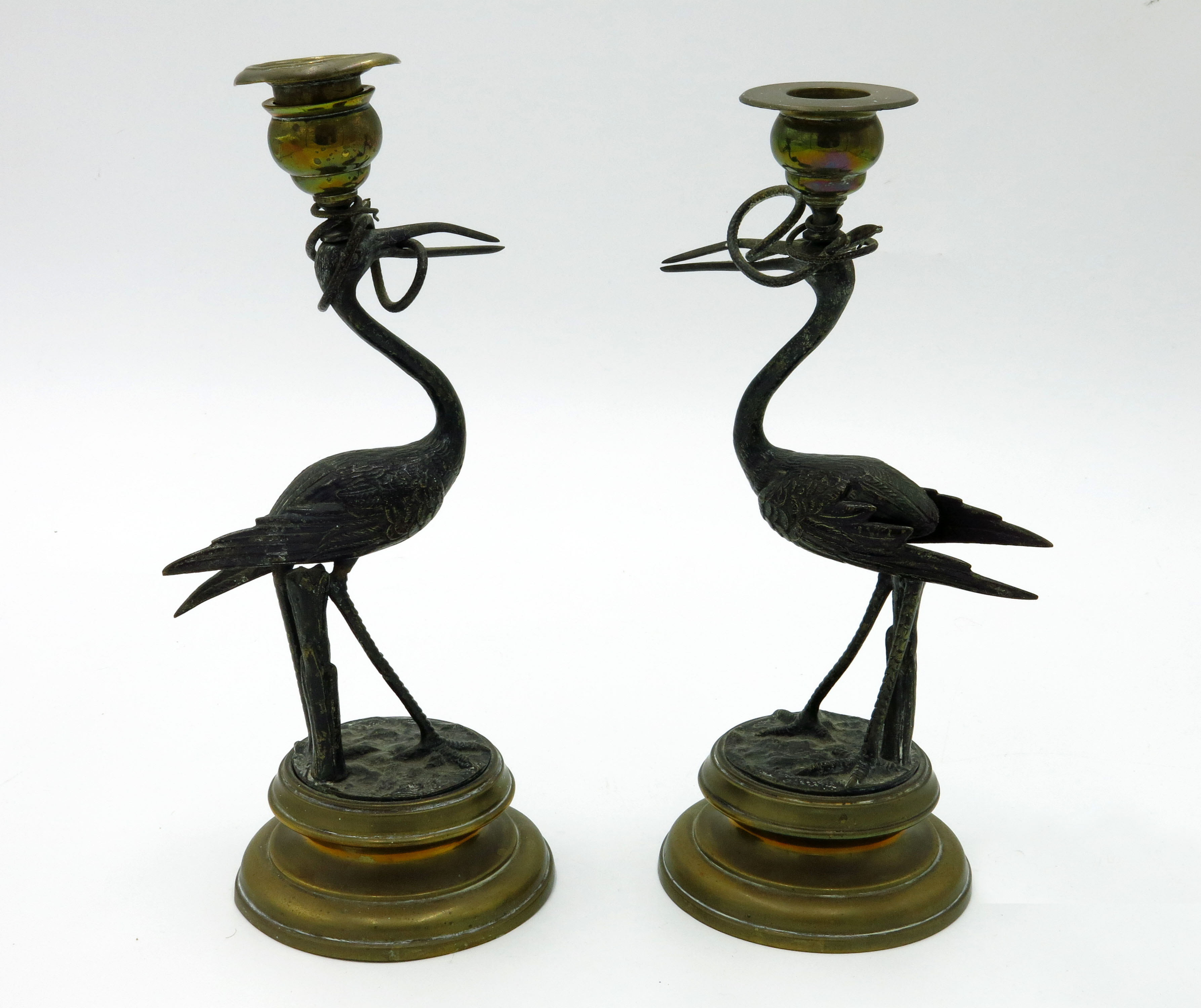 A pair of brass and bronze Regency style candlesticks, 19th century, on circular bases,