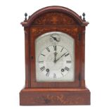 A rosewood and inlaid mantel clock with etched arched silvered dial,