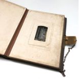 A Victorian leather bound musical photo album, with approximately fifty images, 30 x 23.5cm.