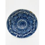 A Delft blue and white shallow dish, 18th century, with stylised floral painted decoration,