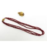 A garnet bead necklace with gold canatille clasp,