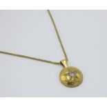 High purity gold discus pendant with central star set with rose cut diamonds on a gold box link