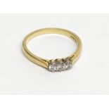 An 18ct gold ring set three diamonds. Condition report: Total weight 4.1g.