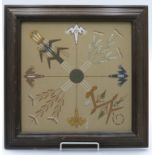 A Mexican sand picture, decorated with stylised frogs and traditional symbols, 29cm square.