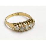 An 18ct gold late Victorian gold ring set five graduated diamonds.