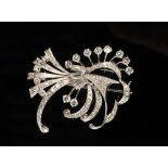 A fine diamond and platinum spray brooch set with brilliant and baguette cut diamonds,