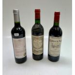 A bottle of Chateau Gazin Pomerol, 1985, and two other bottles of French wine.