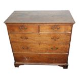 A George III oak chest of drawers, with two short and three long drawers on bracket feet,