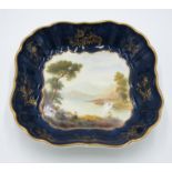 A Royal Worcester porcelain dessert dish, of shaped square section, with blue and gilt border,