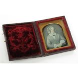 A small Daguerreotype portrait of a seated lady, cased.
