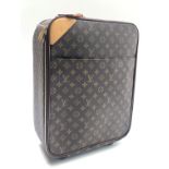 A Louis Vuitton roll along monogram suitcase, cow hide leather trim,