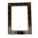 A rectangular black painted mirror frame with applied gilt star and rosette decoration,