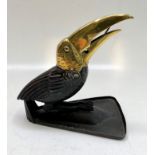 An Arts and Crafts painted steel and brass cigarillo cutter, modelled as a toucan,