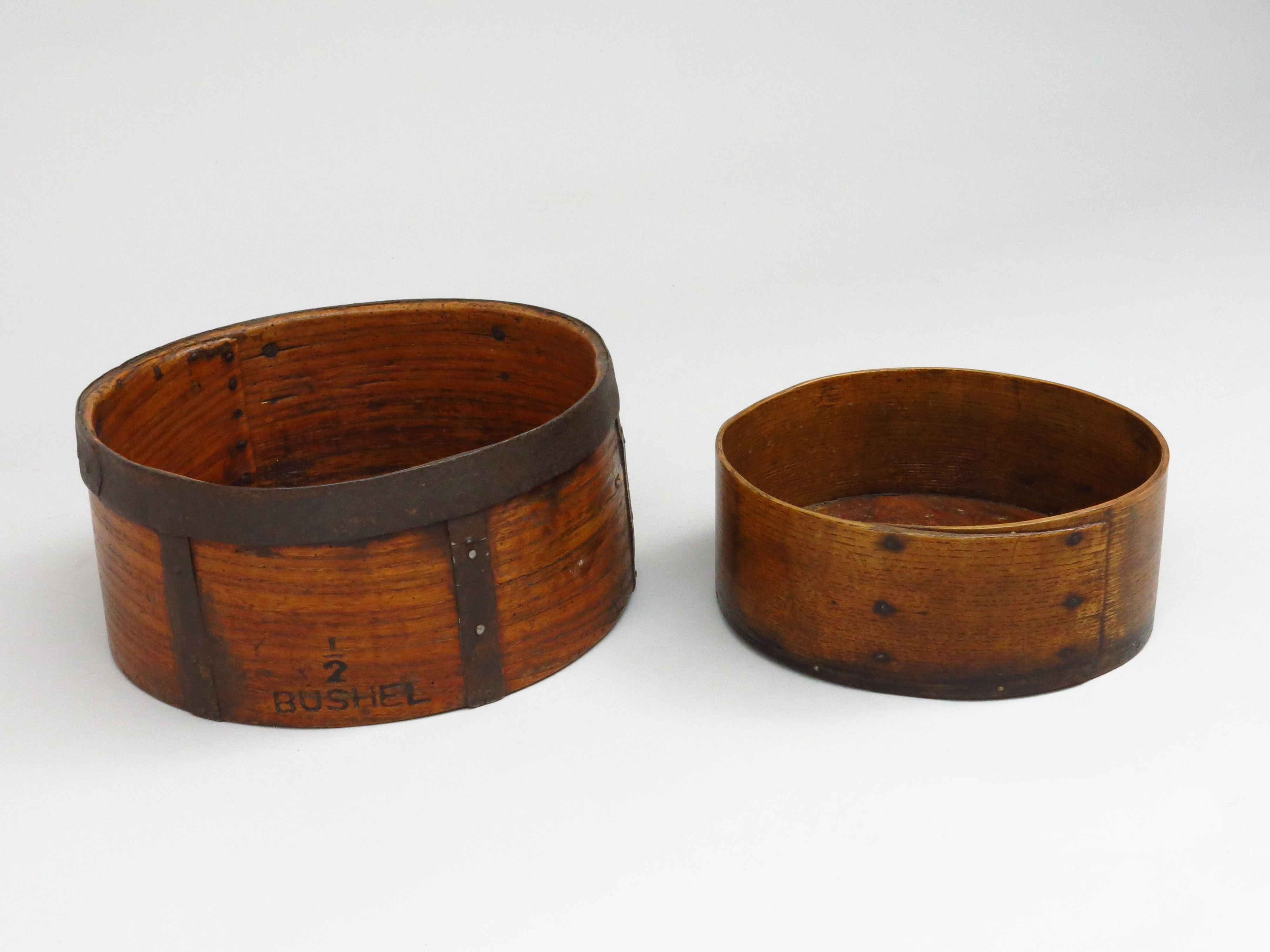 Two Victorian treen grain measures, the largest impressed 'VR 377 1/2 Bushel', diameters 32.