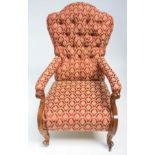 A Victorian walnut gentleman's armchair, with a shaped button upholstered back,