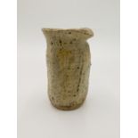 A Teruo Hara ash glaze jug, of uneven form with blistered glaze,